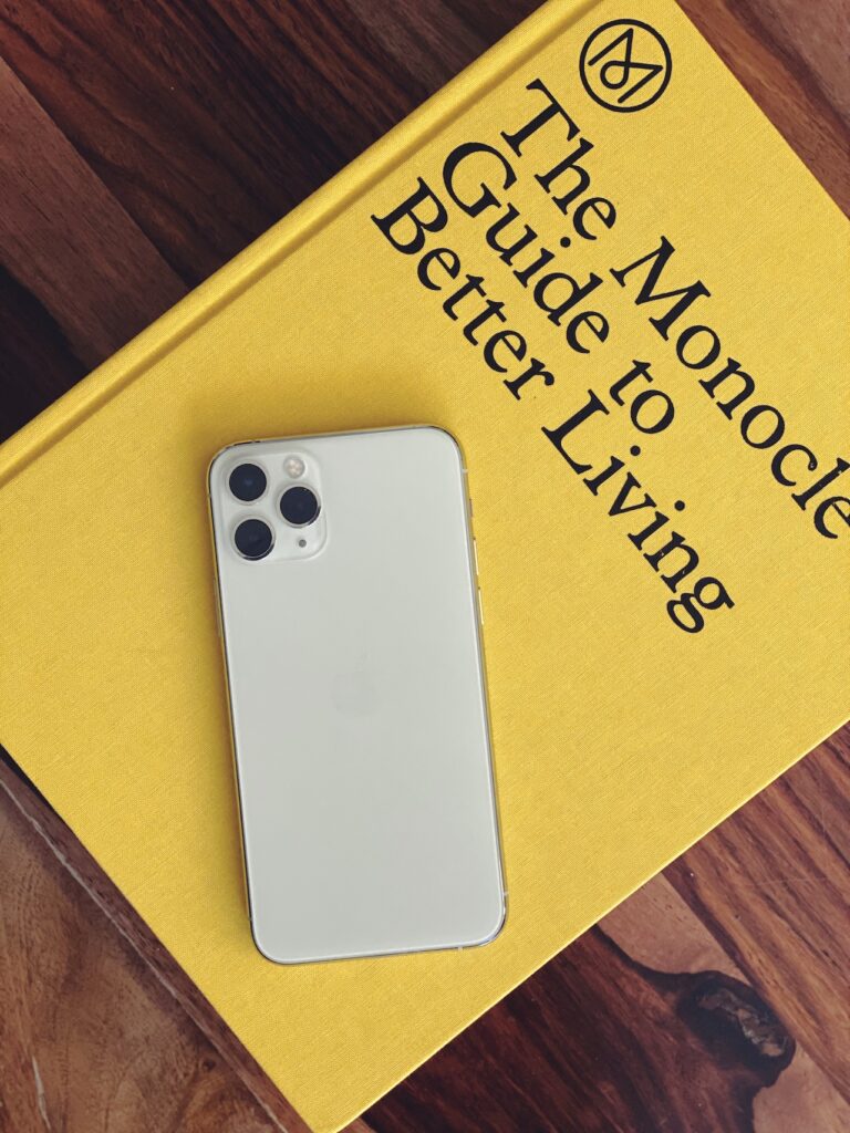 iPhone 11 Pro rear view in silver atop the Monocle Guide To Better Living