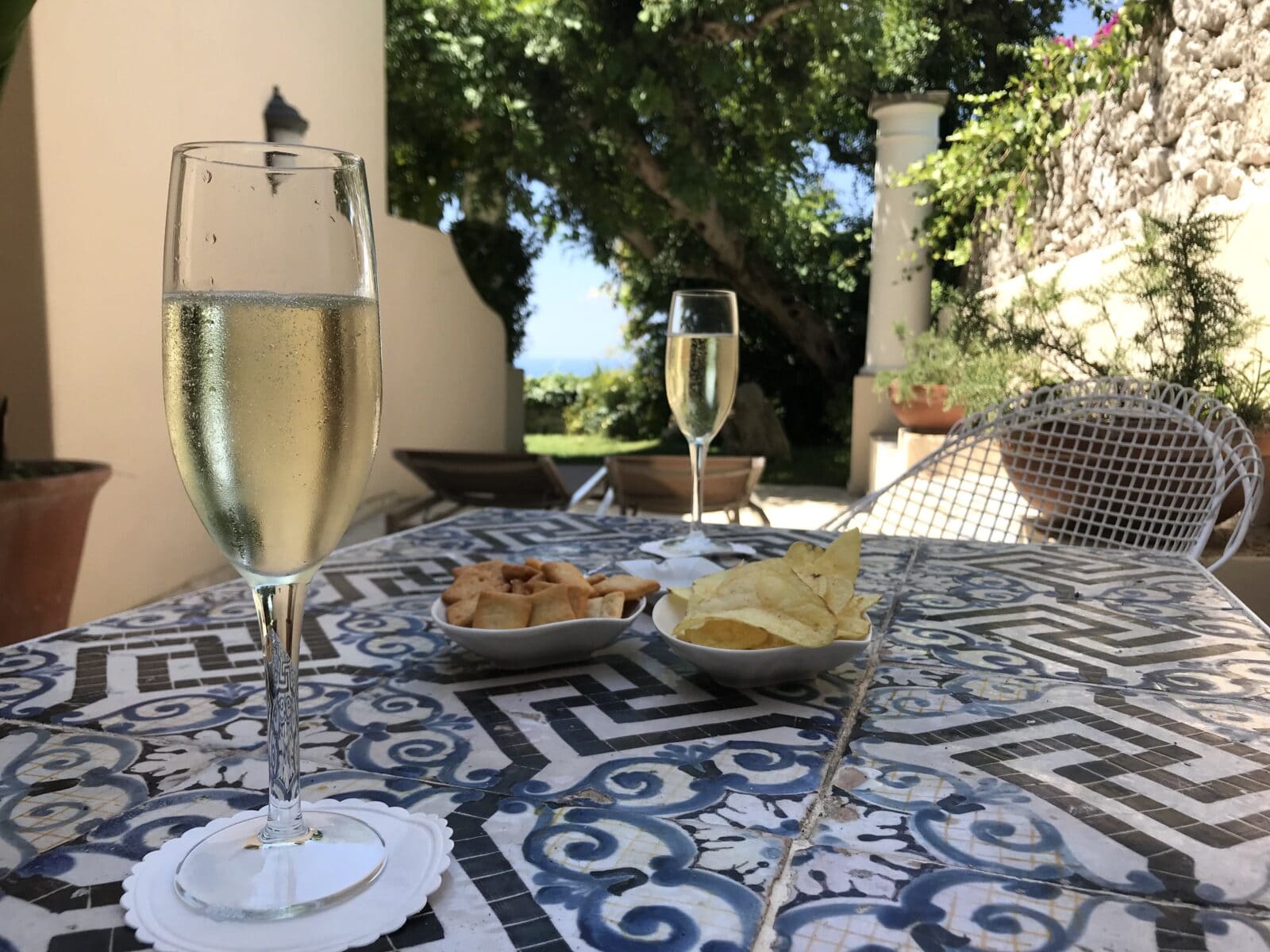 two champagne glasses on a table of snacks