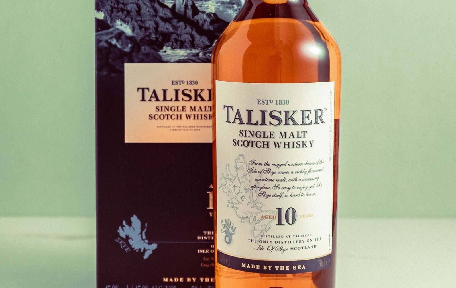 A bottle of Talisker 10 Year Old single malt whiskey next to its box
